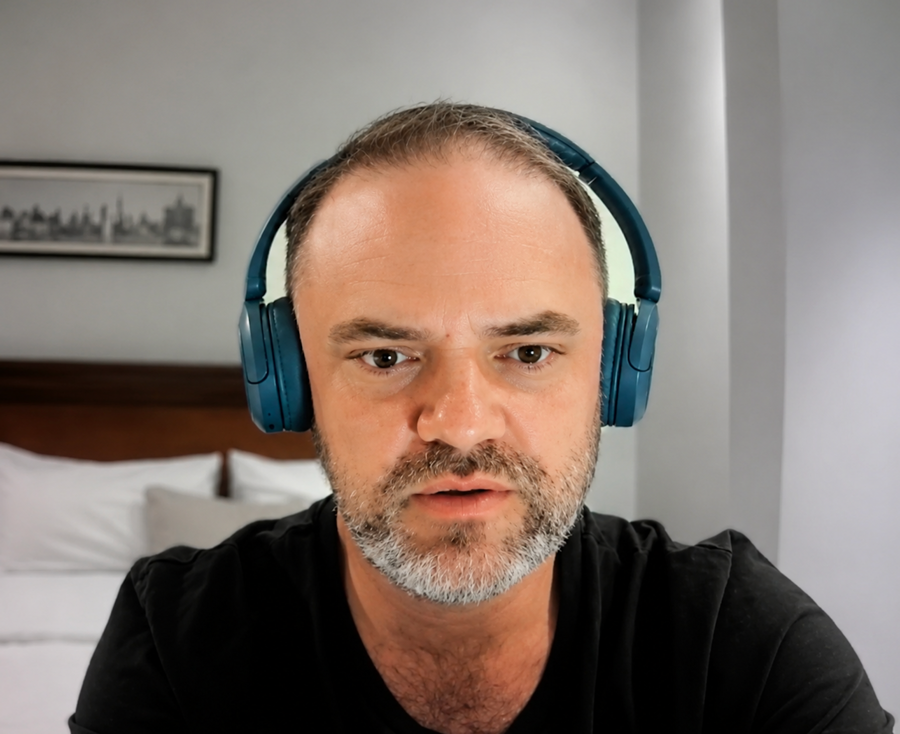 Matt Jope in a black shirt, wearing blue headphones